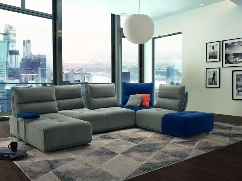Modern cozy living room interior with gray couch or sofa and carpet on a wooden parquet floor. 3d Rendering.